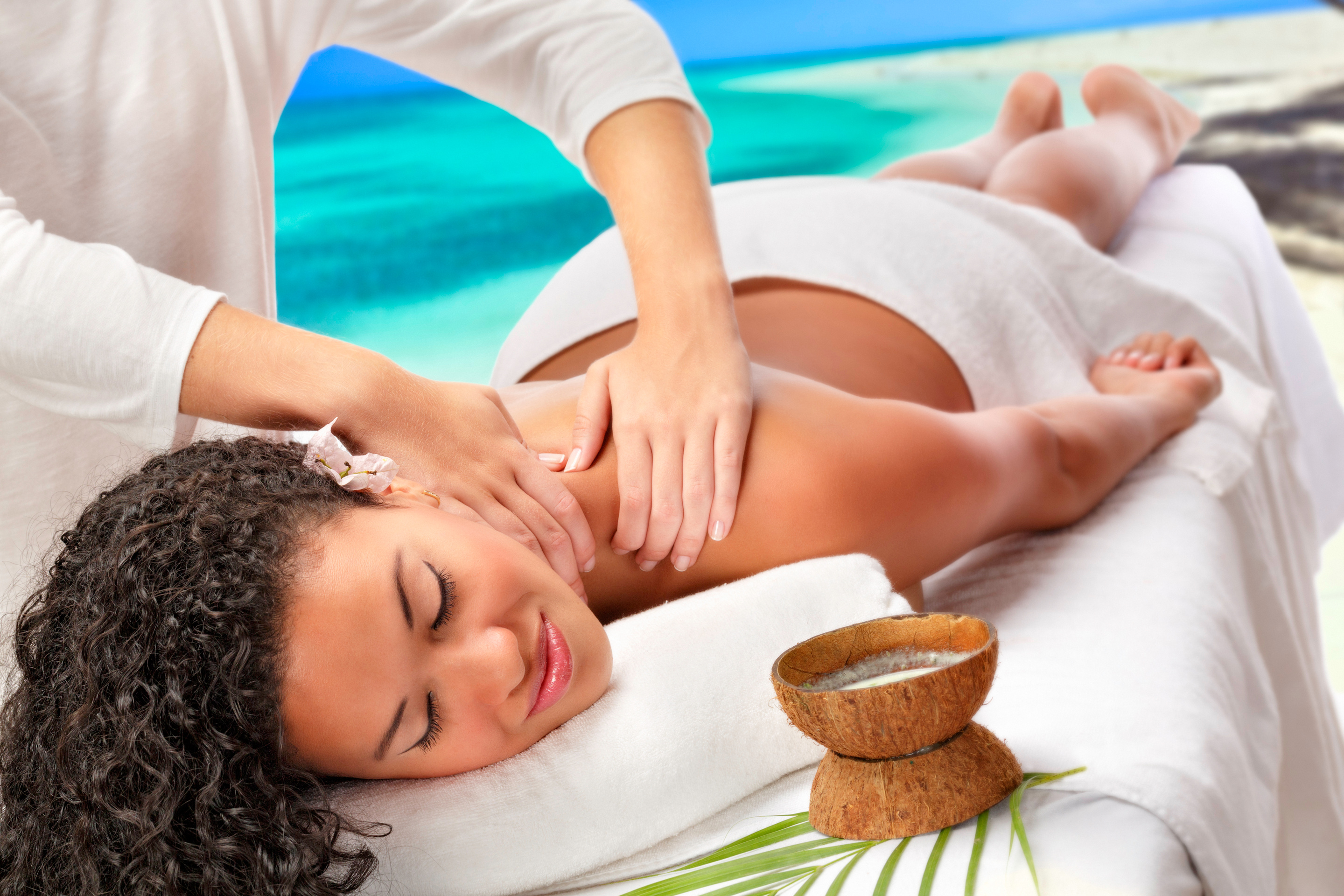 Relaxed African American woman getting massage therapy beach Spa